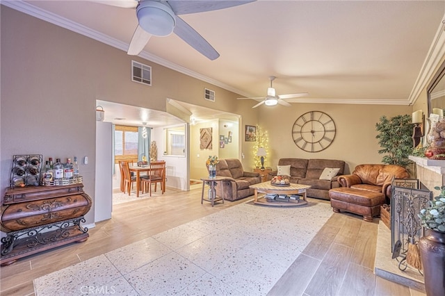 living room with ornamental molding, ceiling fan, and light wood-type flooring