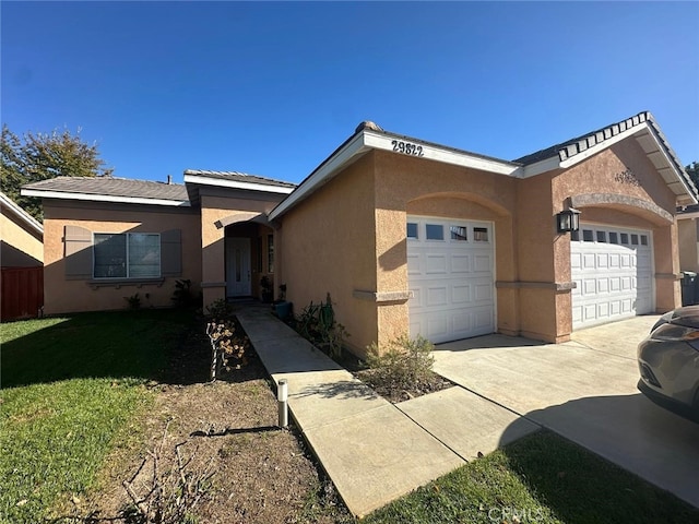 29822 Cool Meadow Dr, Menifee, CA 92584 - view of front facade with a garage, stucco siding, concrete driveway, and a front yard
