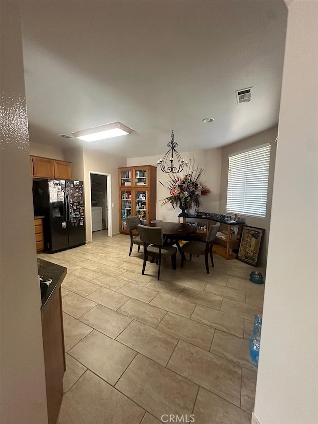 29822 Cool Meadow Dr, Menifee, CA 92584 - dining space featuring a chandelier, light tile patterned floors, and washer / clothes dryer