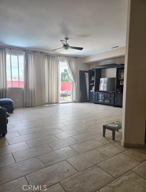 29822 Cool Meadow Dr, Menifee, CA 92584 - unfurnished living room featuring a ceiling fan and tile patterned floors