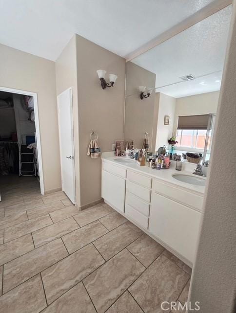 29822 Cool Meadow Dr, Menifee, CA 92584 - full bathroom with double vanity, a spacious closet, and tile patterned flooring