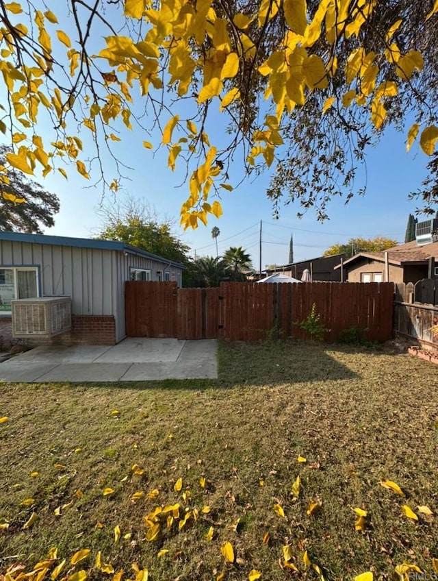 view of yard with cooling unit and a patio area