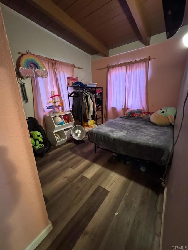 bedroom with beamed ceiling, hardwood / wood-style flooring, and wooden ceiling