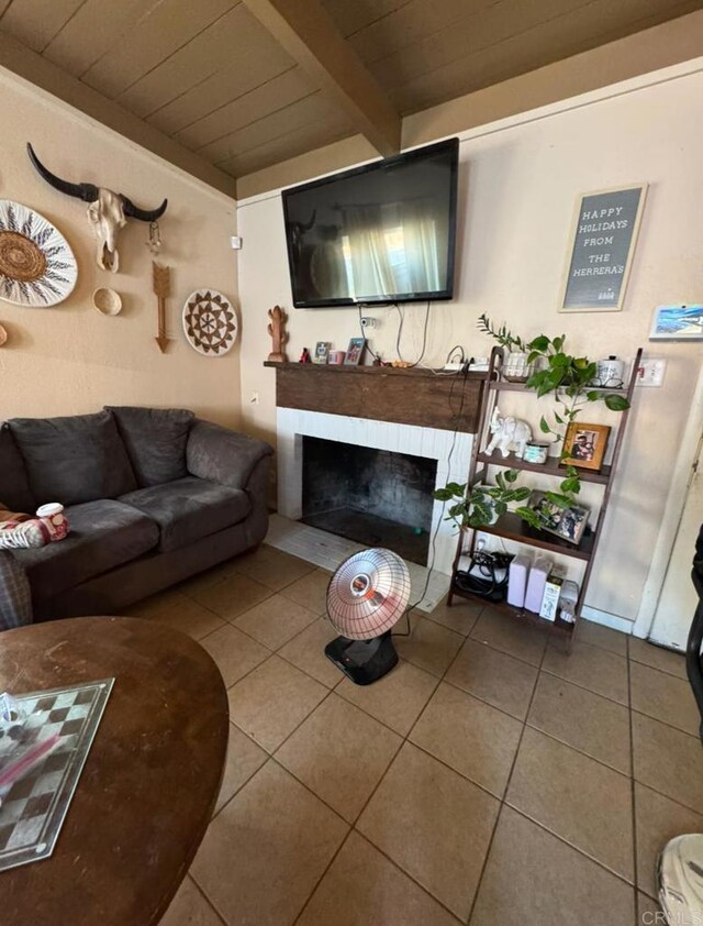 tiled living room with beamed ceiling, a brick fireplace, and wooden ceiling