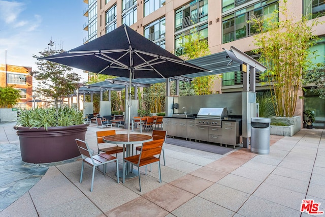 view of patio featuring area for grilling, sink, and exterior kitchen