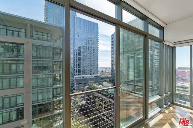 interior space with floor to ceiling windows, hardwood / wood-style flooring, and a wealth of natural light