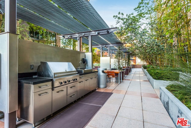 view of patio with area for grilling, sink, and grilling area