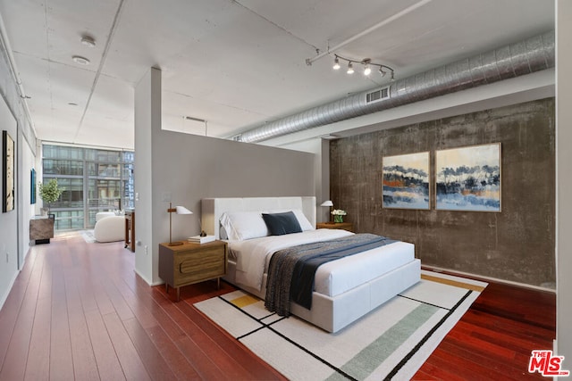 bedroom featuring hardwood / wood-style floors and floor to ceiling windows