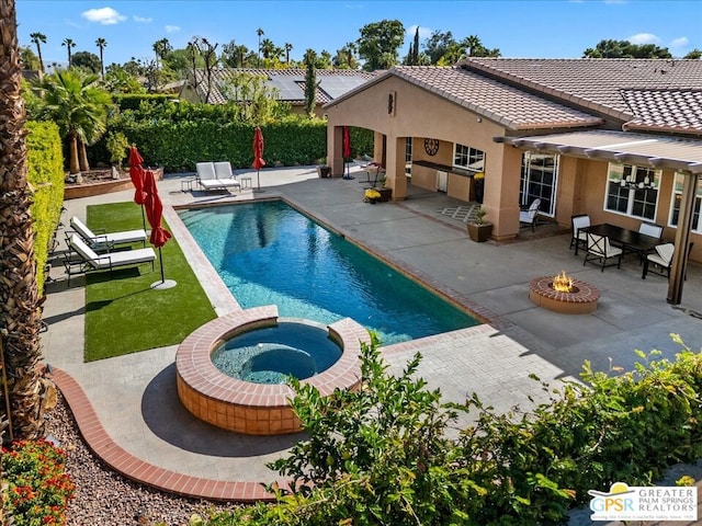 view of pool featuring an in ground hot tub, a patio, and an outdoor fire pit