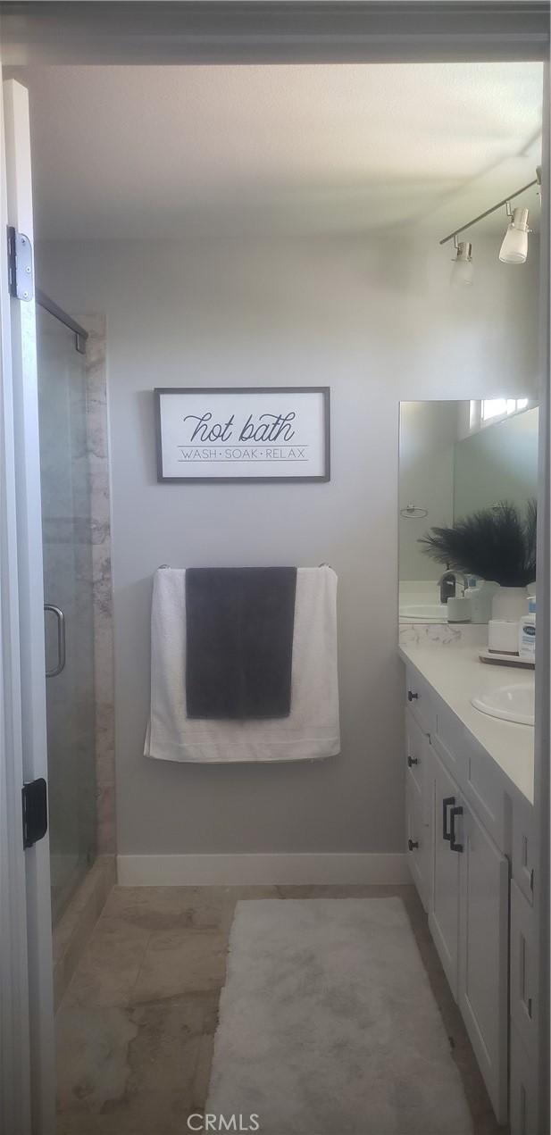 bathroom with vanity and an enclosed shower