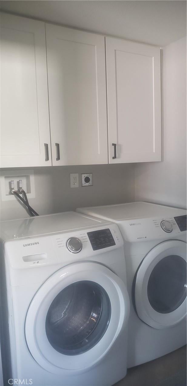 laundry area with cabinets and independent washer and dryer