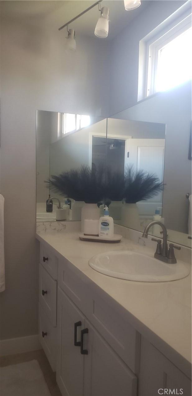 bathroom with plenty of natural light and vanity