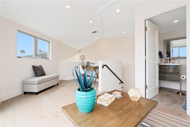 office featuring vaulted ceiling, light hardwood / wood-style flooring, and plenty of natural light