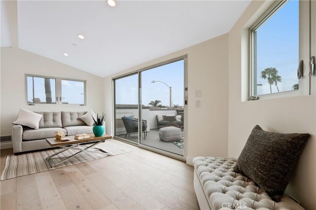 interior space with light hardwood / wood-style floors and vaulted ceiling