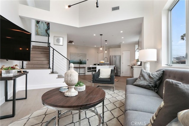 living room featuring light wood-type flooring and a wealth of natural light