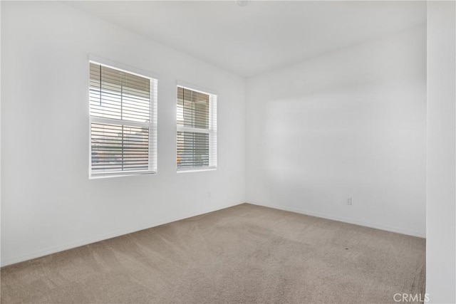 unfurnished room with light colored carpet