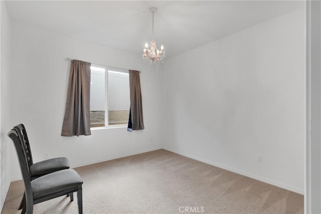 sitting room featuring a chandelier and carpet floors