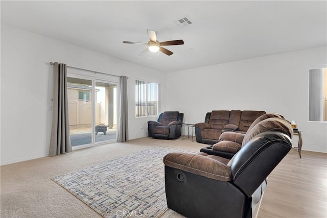 living room featuring ceiling fan and light hardwood / wood-style floors