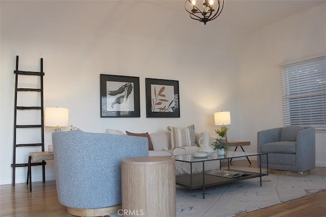 living room with hardwood / wood-style floors and a notable chandelier