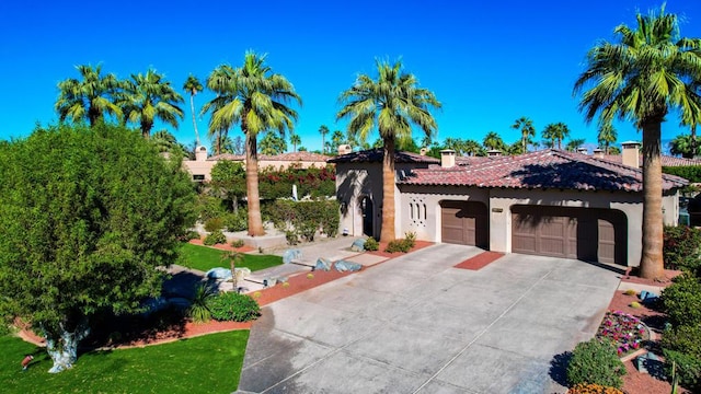 mediterranean / spanish home featuring a garage