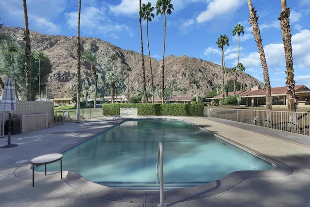 view of pool featuring a mountain view and a patio area