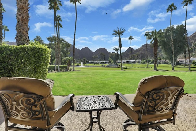 view of community with a lawn and a mountain view