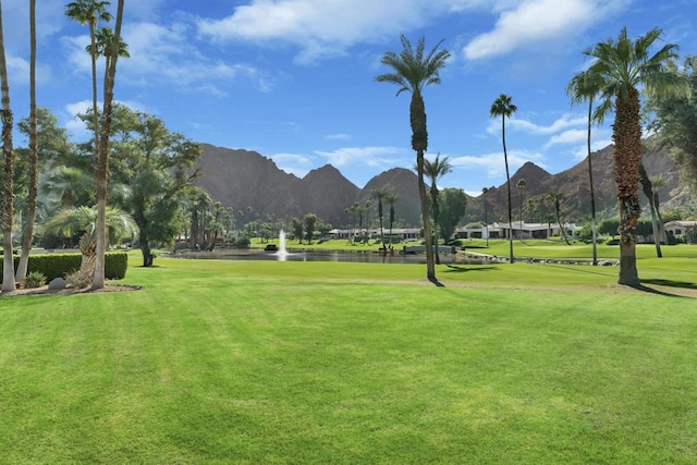 surrounding community featuring a mountain view and a lawn