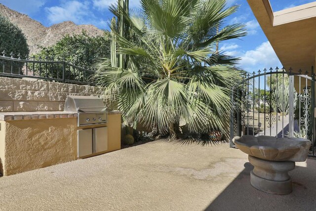 view of patio / terrace with a mountain view, area for grilling, and grilling area