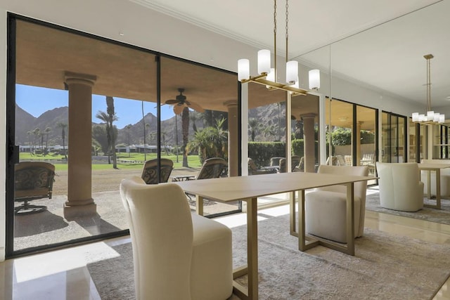 dining space with a mountain view, ceiling fan, and crown molding