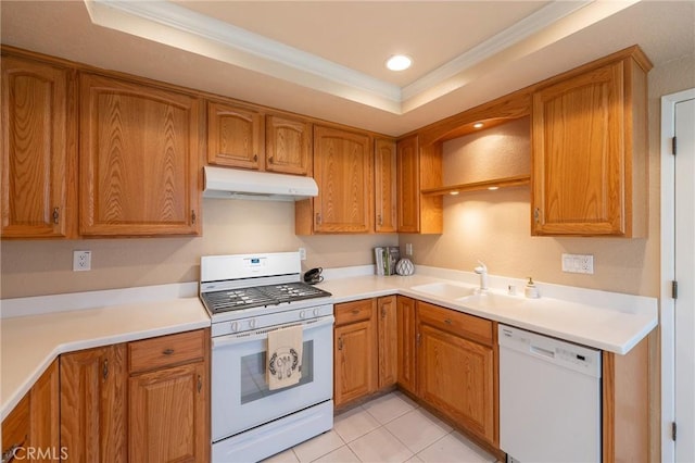 kitchen featuring sink, a raised ceiling, white appliances, and crown molding