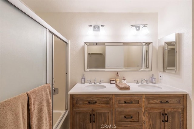 bathroom featuring vanity and bath / shower combo with glass door