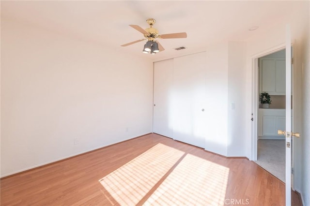 spare room featuring ceiling fan and light hardwood / wood-style floors