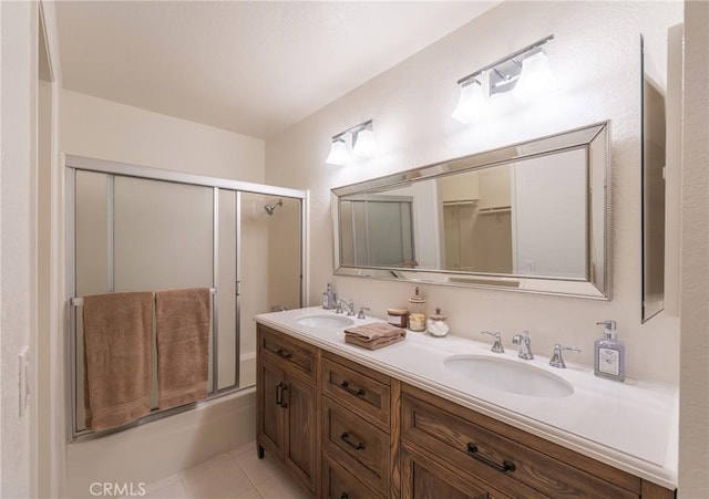 bathroom with tile patterned floors, vanity, and enclosed tub / shower combo