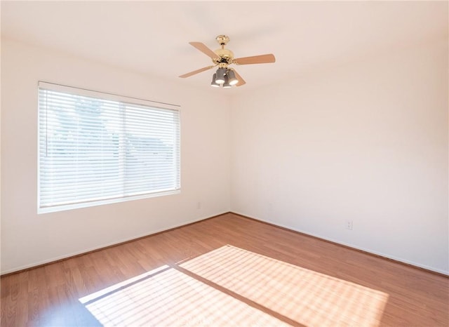 empty room featuring hardwood / wood-style flooring and ceiling fan