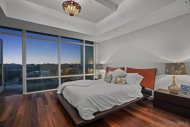 bedroom with hardwood / wood-style floors and expansive windows