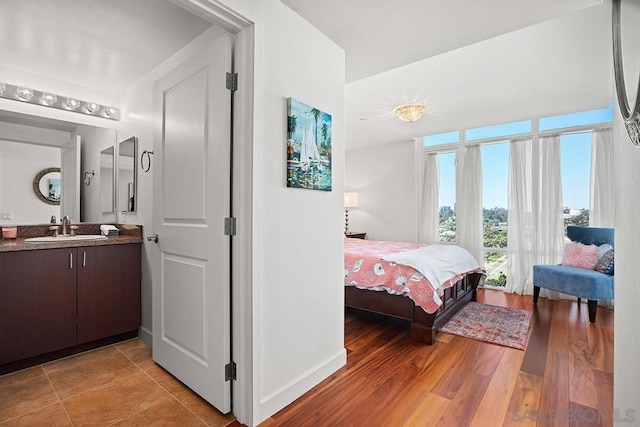 bedroom with light hardwood / wood-style floors and sink