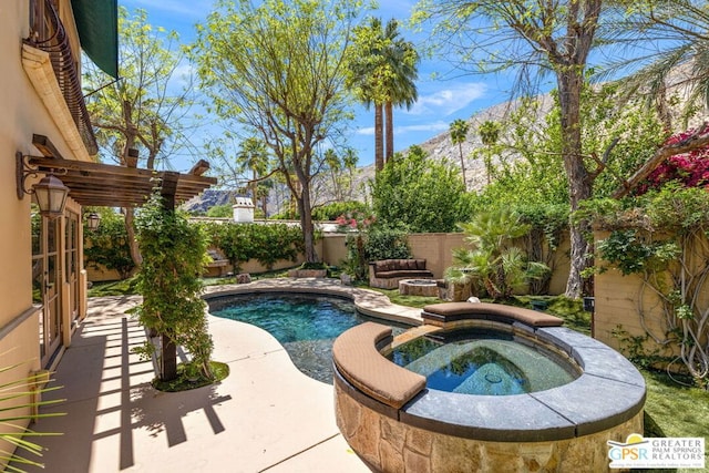 view of swimming pool with an in ground hot tub