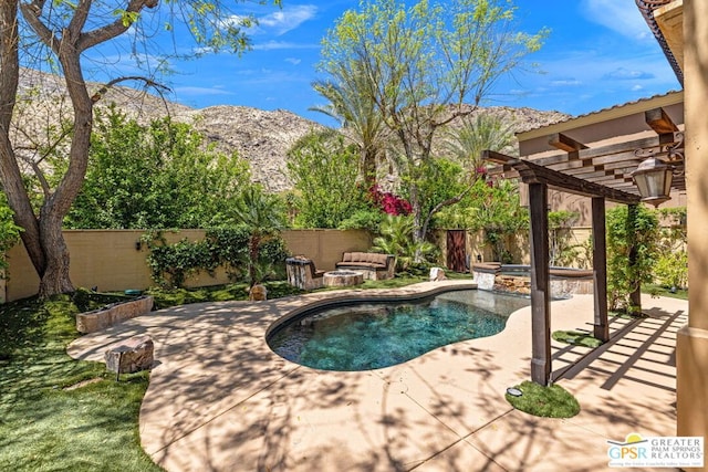 view of pool with a mountain view, a patio area, a pergola, and an in ground hot tub