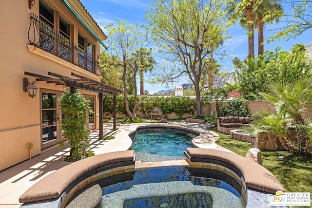 view of pool with an in ground hot tub and a patio