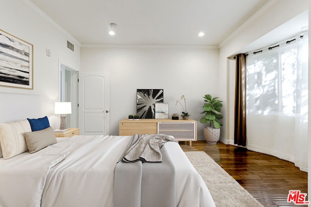 bedroom featuring crown molding and dark wood-type flooring