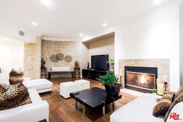 living room with wood-type flooring and ornamental molding