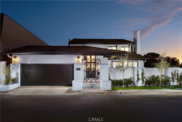 1 Rue Du Parc, Newport Beach, CA 92660 - contemporary home featuring an attached garage, concrete driveway, stucco siding, and a chimney
