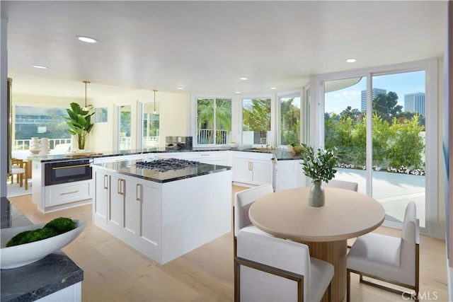 1 Rue Du Parc, Newport Beach, CA 92660 - kitchen featuring a center island, white cabinetry, stainless steel gas cooktop, recessed lighting, and plenty of natural light