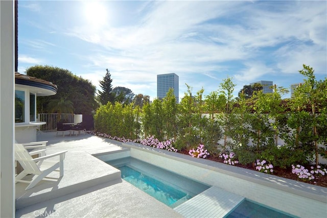 view of pool with a hot tub