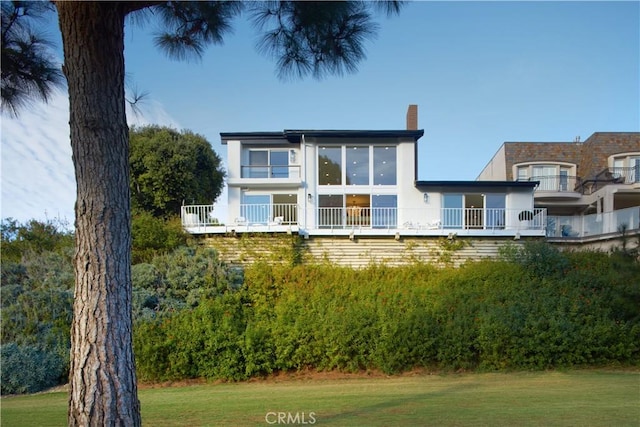 1 Rue Du Parc, Newport Beach, CA 92660 - view of front of home with a chimney, a front yard, and stucco siding