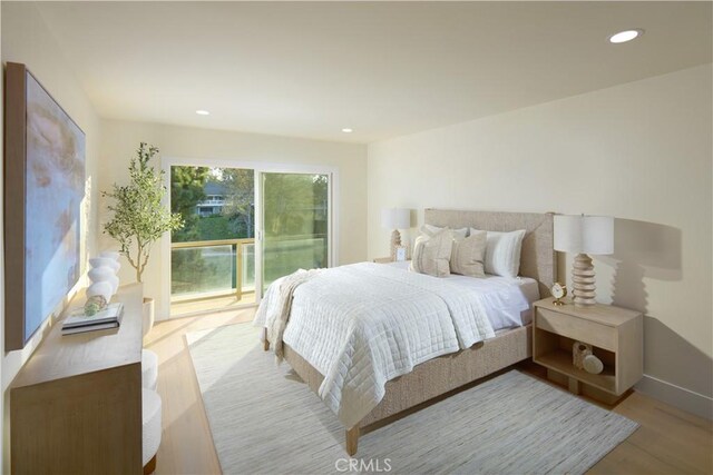 bedroom with access to exterior and light hardwood / wood-style floors