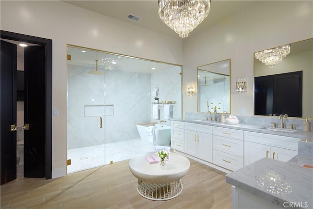 1 Rue Du Parc, Newport Beach, CA 92660 - bathroom with a chandelier, a marble finish shower, a freestanding bath, and double vanity