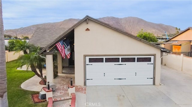 view of front of home featuring a mountain view and a garage