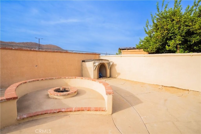 view of patio with an outdoor fire pit