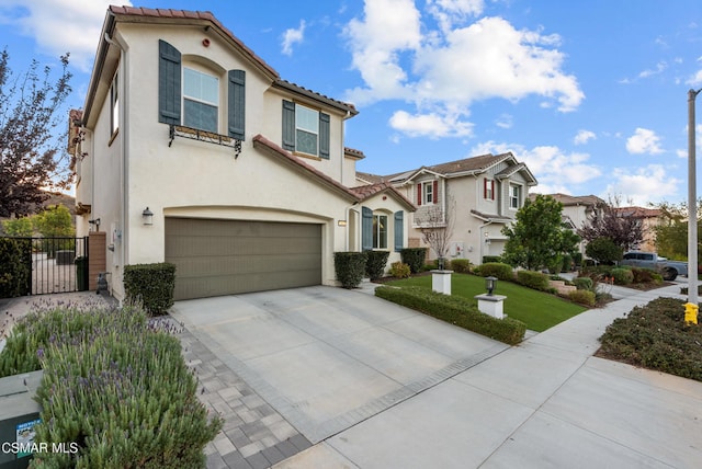 mediterranean / spanish house featuring a front yard and a garage